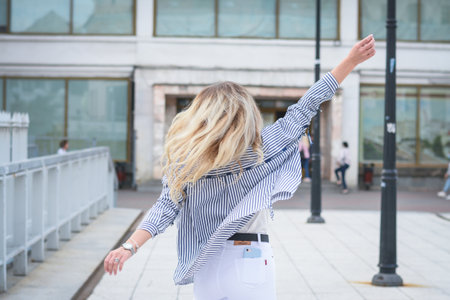 Lifestyle concept, A beautiful girl is spinning on the street of her cityの写真素材