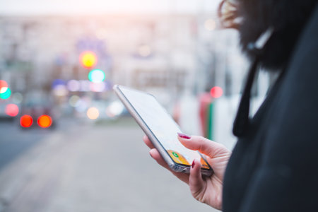 Woman Hands Texting On A Smart Phone With Urban Background close upの写真素材