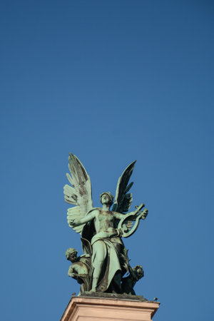 Angel statue with wings on a blue sky backgroundの写真素材