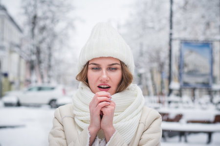 sensitive winter portrait of a beautiful girl on the street of a winter cityの写真素材