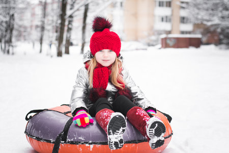 Happy Baby Girl portrait In red Hat Outdoor Winter Backgroundの写真素材