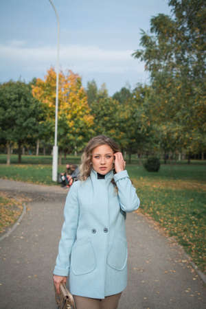 Beautiful girl autumn portrait in the cityの写真素材