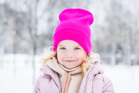 Beautiful little girl portrait in winter in the parkの写真素材
