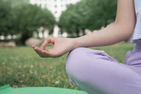 Attractive young woman doing yoga outsideの写真素材