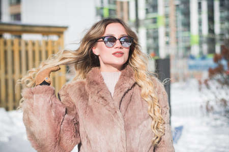 Beautiful stylish russian girl model in winter in the city