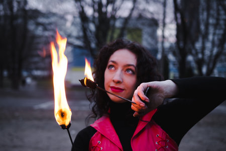 A girl shows a fire show in the nightの写真素材