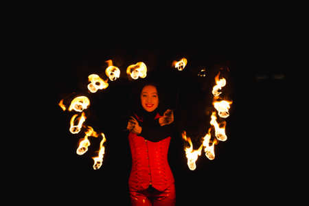 A girl shows a fire show