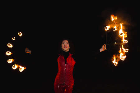 A girl shows a fire show
