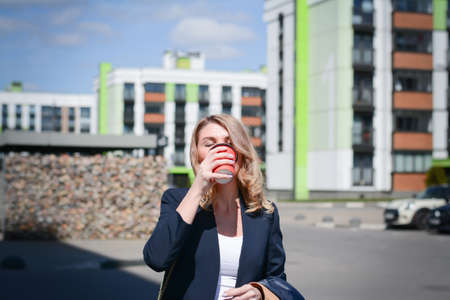 Business woman with a cup of coffee in the business centerの写真素材