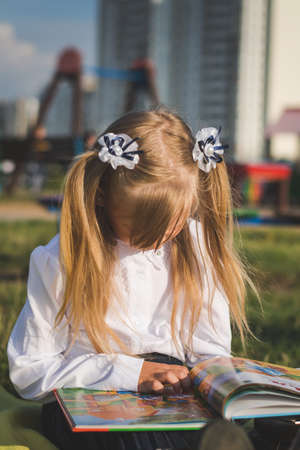 Little girl portrait on the playground in summer