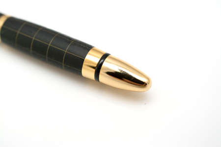 Old golden pen isolated on white background