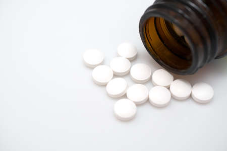 white pills heap isolated on white background