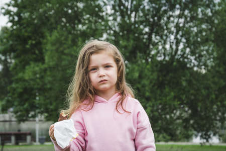 Beautiful happy little girl portrait in city parkの写真素材