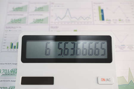 Business concept, white digital calculator close up