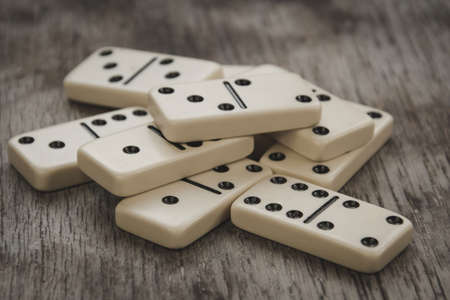 Dice and dominoes on wooden table, casino luck or big win conceptの写真素材