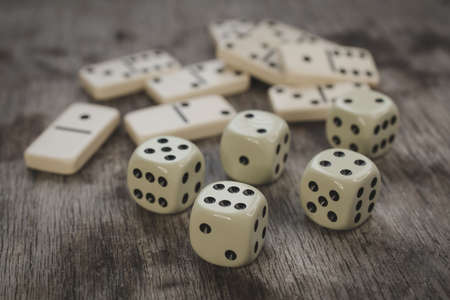Dice and dominoes on wooden table, casino luck or big win conceptの写真素材