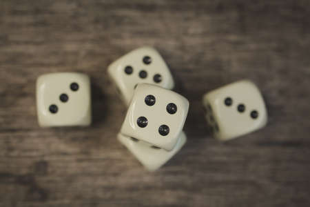 Playing cubes on a wooden table close