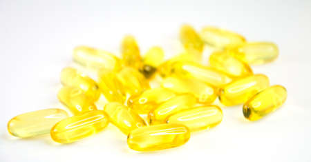 Omega 3 vitamins and vitamin d capsules isolated on white backgroundの写真素材