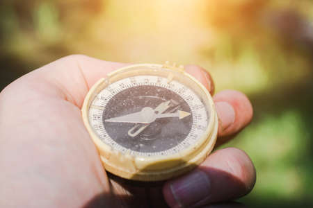 An old tourist compass in the woods