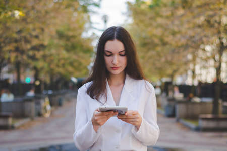 Beautiful white business woman with a tablet in an urban environment, online commerce concept