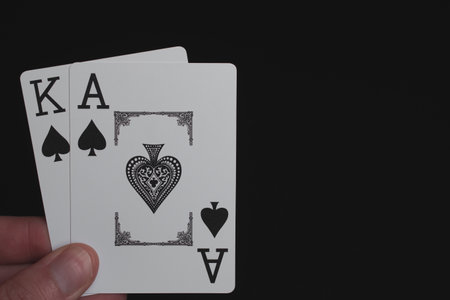 Playing cards Ace of Spades on a black background and King of Spades on a black backgroundの写真素材