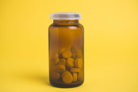 head pill isolated on yellow backgroundの写真素材