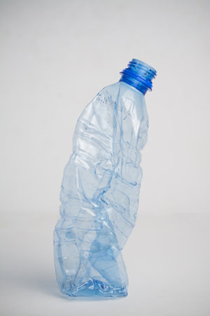 Crumpled plastic bottle on white backgroundの写真素材