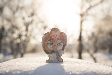 Little Christmas angel toy in the snowの写真素材