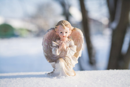 Little Christmas angel toy in the snow