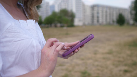 Woman hands using smartphone outside close upの写真素材