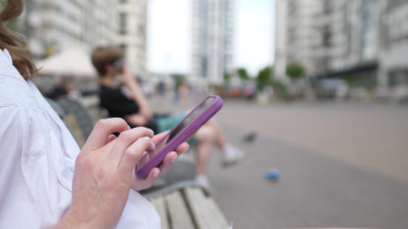 Woman hands using smartphone outside close upの写真素材
