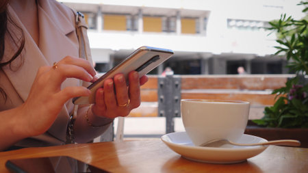 phone and woman in park for typing social mediaの写真素材