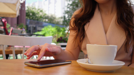 phone and woman in park for typing social mediaの写真素材