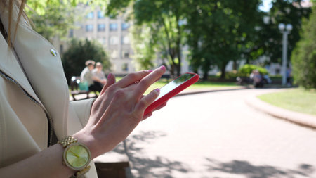 Woman hands using smartphone outside close upの写真素材