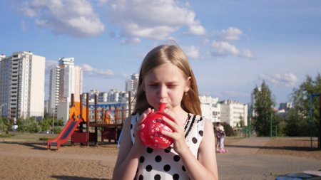 beautiful little happy girl portrait in summer in children's park 4kの写真素材