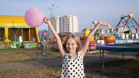 beautiful little happy girl portrait in summer in children's park 4kの写真素材