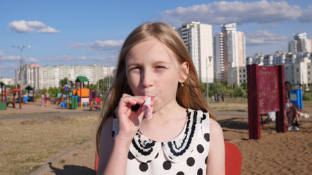 beautiful little happy girl portrait in summer in children's park 4kの写真素材