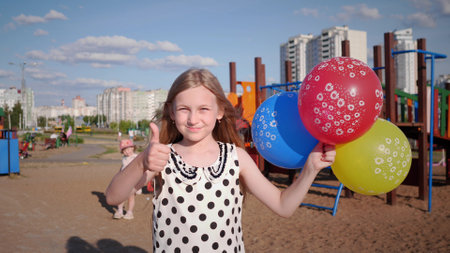 beautiful little happy girl portrait in summer in children's park 4kの写真素材