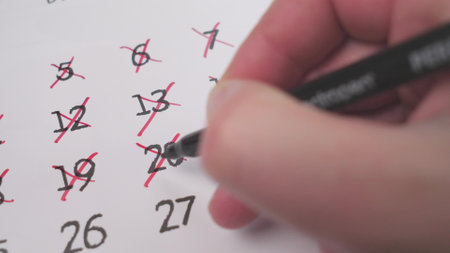 Daily Planner Marking Completed Dates on a Calendar for Better Organization and Trackingの写真素材