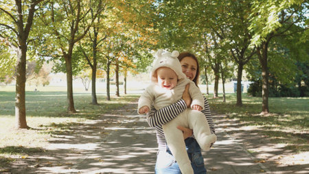 A Joyful Mother and her Baby Enjoying a Beautiful Day in the Autumn Park Together