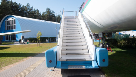 Vintage Soviet Aircraft on Display With Stairs Leading up to Its Entrance in a Museum Setting...