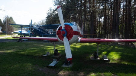 Vintage Soviet Aircraft Displayed in a Forested Area, Showcasing the Unique Design and Engineering...