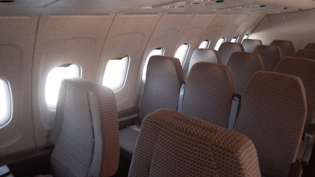 Vintage Interior of a Soviet Aircraft Showcasing the Seating Arrangement and Windows Along the Side During the Late 20th Century in Russiaの写真素材