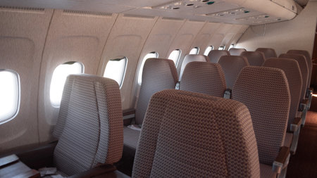 Vintage Interior of a Soviet-era Aircraft Showcasing Seating Arrangement and Window Design From the USSR Period in Russiaの写真素材