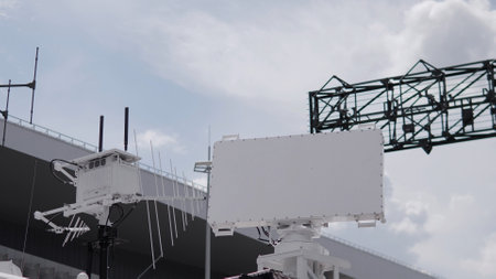 Advanced radar system showcased at a testing facility, equipped with antennas and monitoring capabilities, operating on a cloudy day with dramatic skies.の写真素材