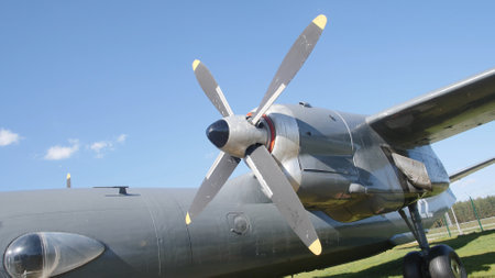 A vintage propeller aircraft showcases its robust design at an outdoor airshow. The clear blue skies create a perfect backdrop for this exciting aviation event.の写真素材