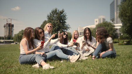 A lively group of friends are enjoying a sunny day outdoors, laughing together and having fun