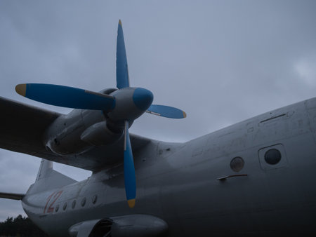 vintage aircraft with ground crew present, sunset scene showing aged turboprop aircraft and ground...
