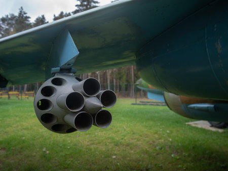 rocket tube inspection, evaluating rocket launcher tubes beneath aircraft wings with maintenance...