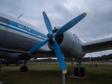 old aircraft under cloudy sky, antique propeller aircraft showcased amidst overcast weather and...